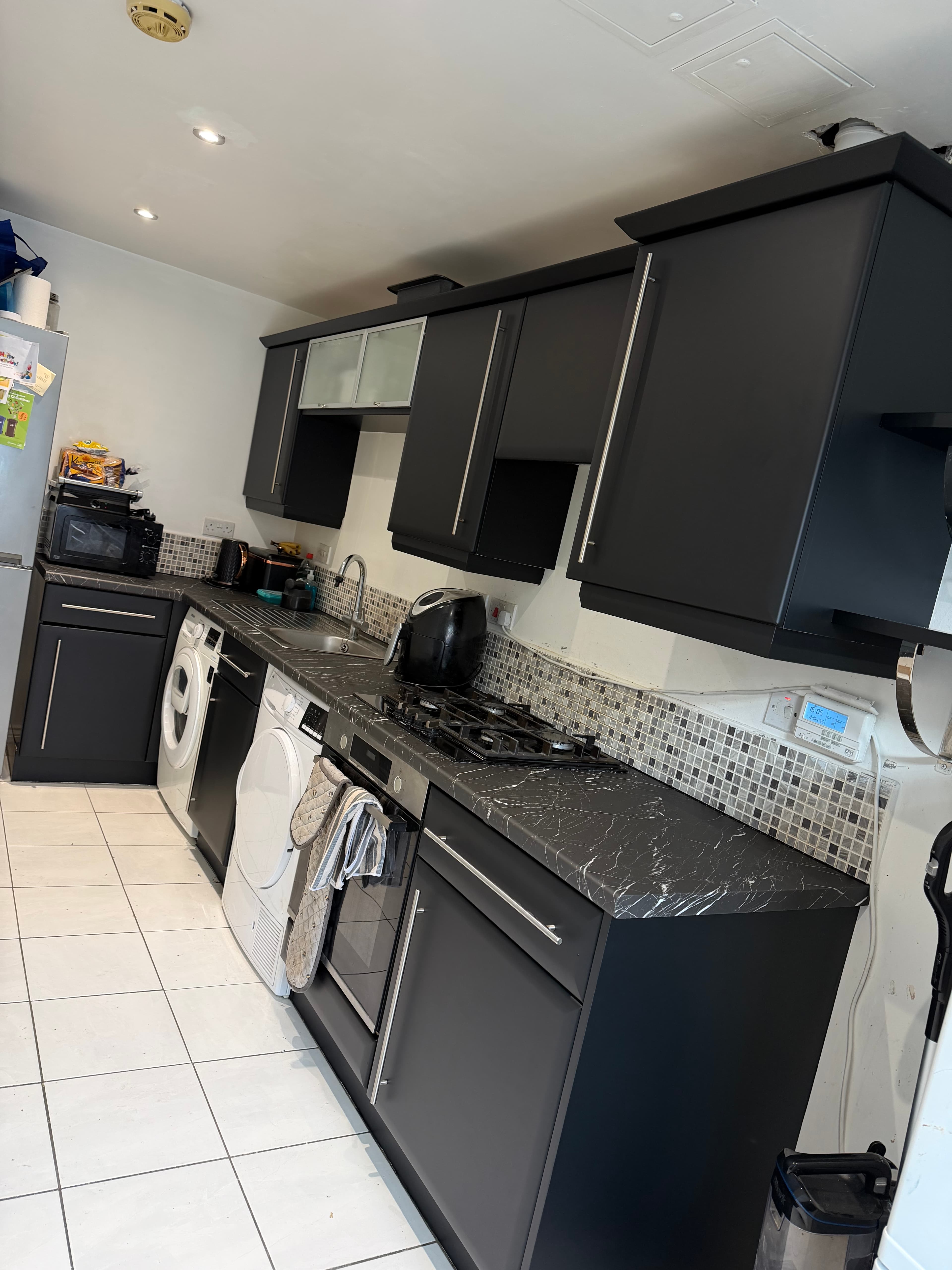 Same Sheffield kitchen after matt black wrap and marble worktops
